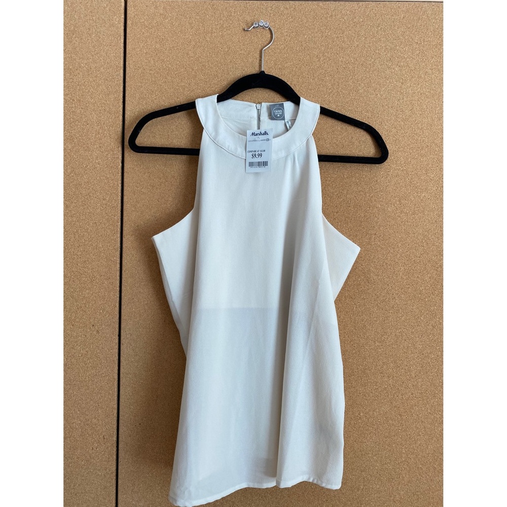 Sheer, classy, sleeveless cream-colored blouse